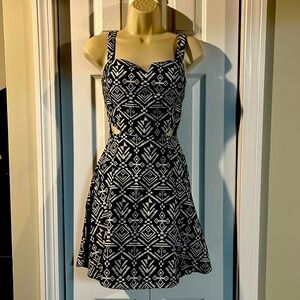 Small and short women dress. Has cutout on each side by waist.